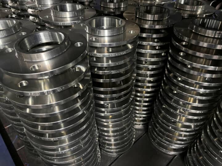Image of stacks of steel flanges in our factory